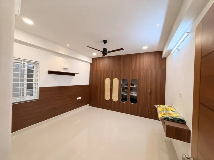 Bedroom with walnut wall panelling and a built-in wardrobe