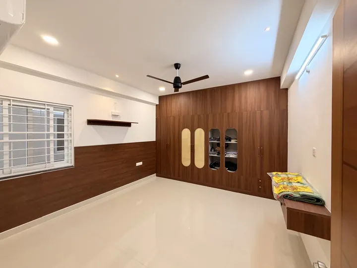 Wide view of the bedroom and walnut wardrobe wall