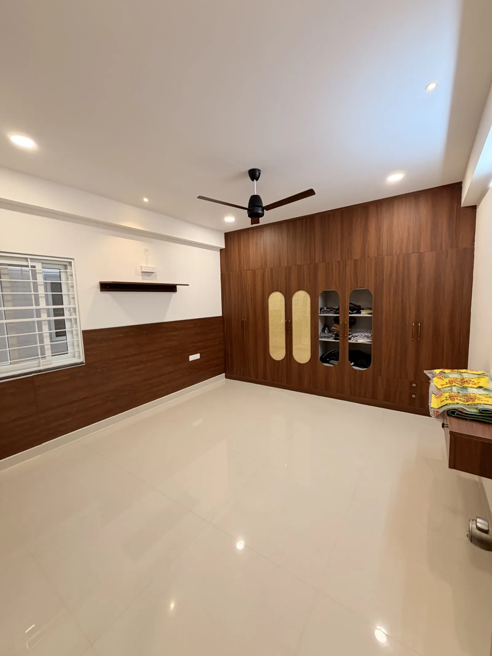 Closer view of the walnut wardrobe and room corner
