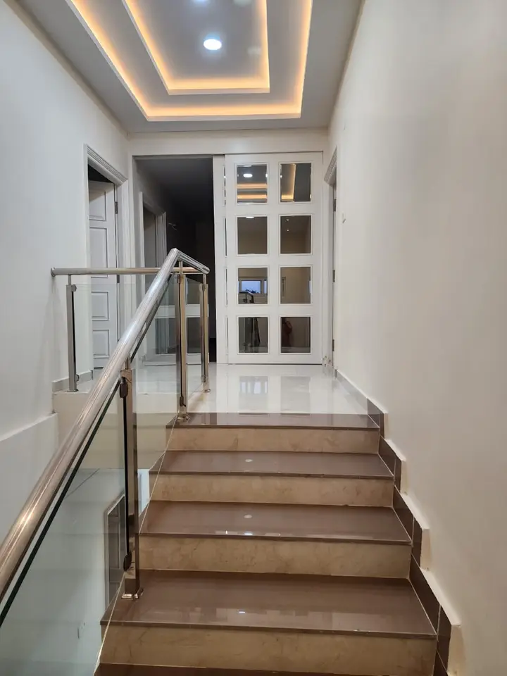 Stair landing with white lattice-panelled doors