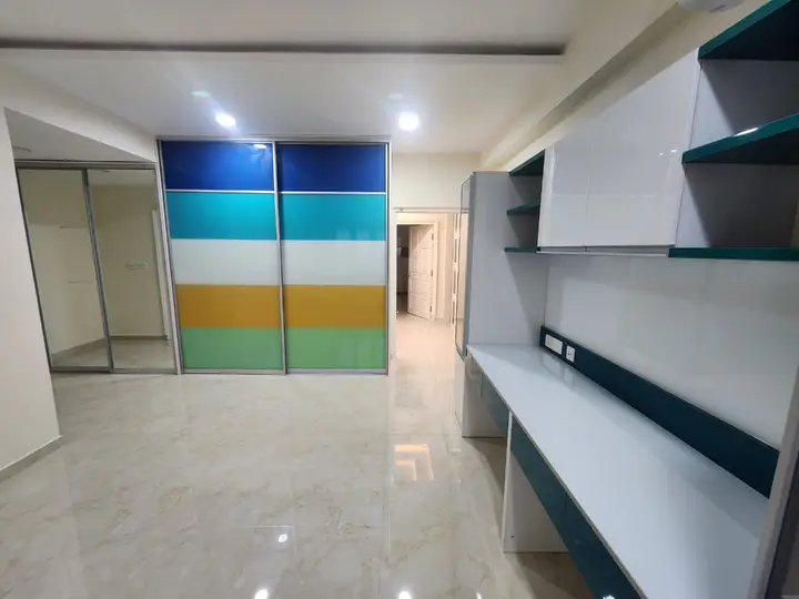 Study wall with a colour-block wardrobe and white shelves