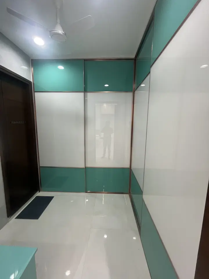Teal-edged wardrobe in a bedroom corner