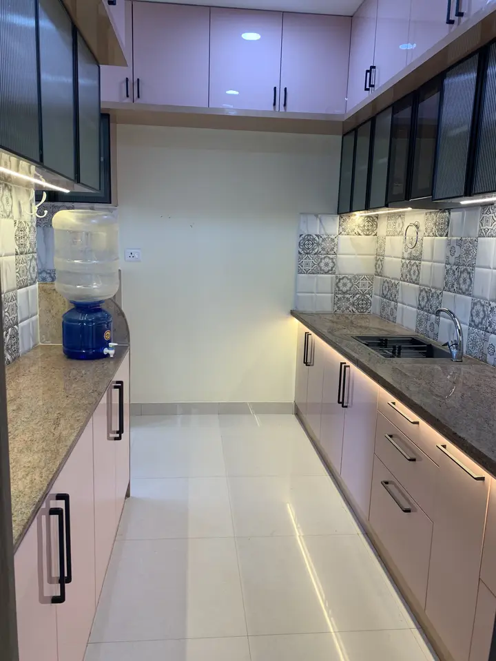 Narrow kitchen with pink shutters and patterned tile