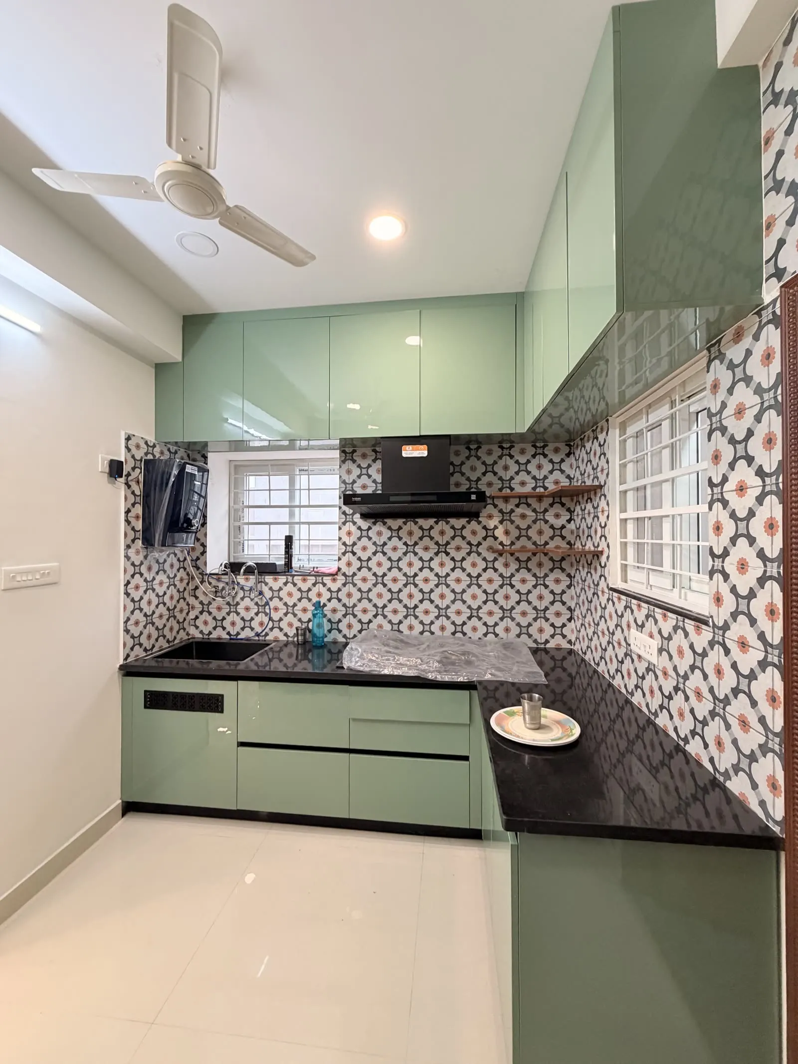 Muted green kitchen with patterned tile backsplash