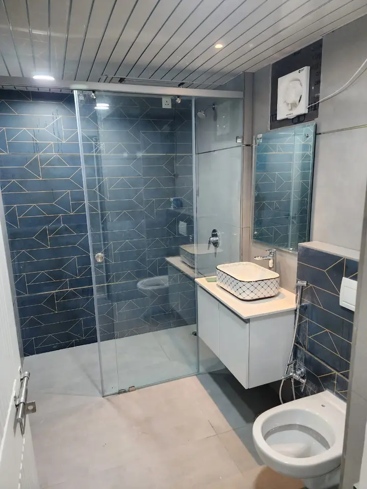 Blue patterned tile bathroom with a floating vanity