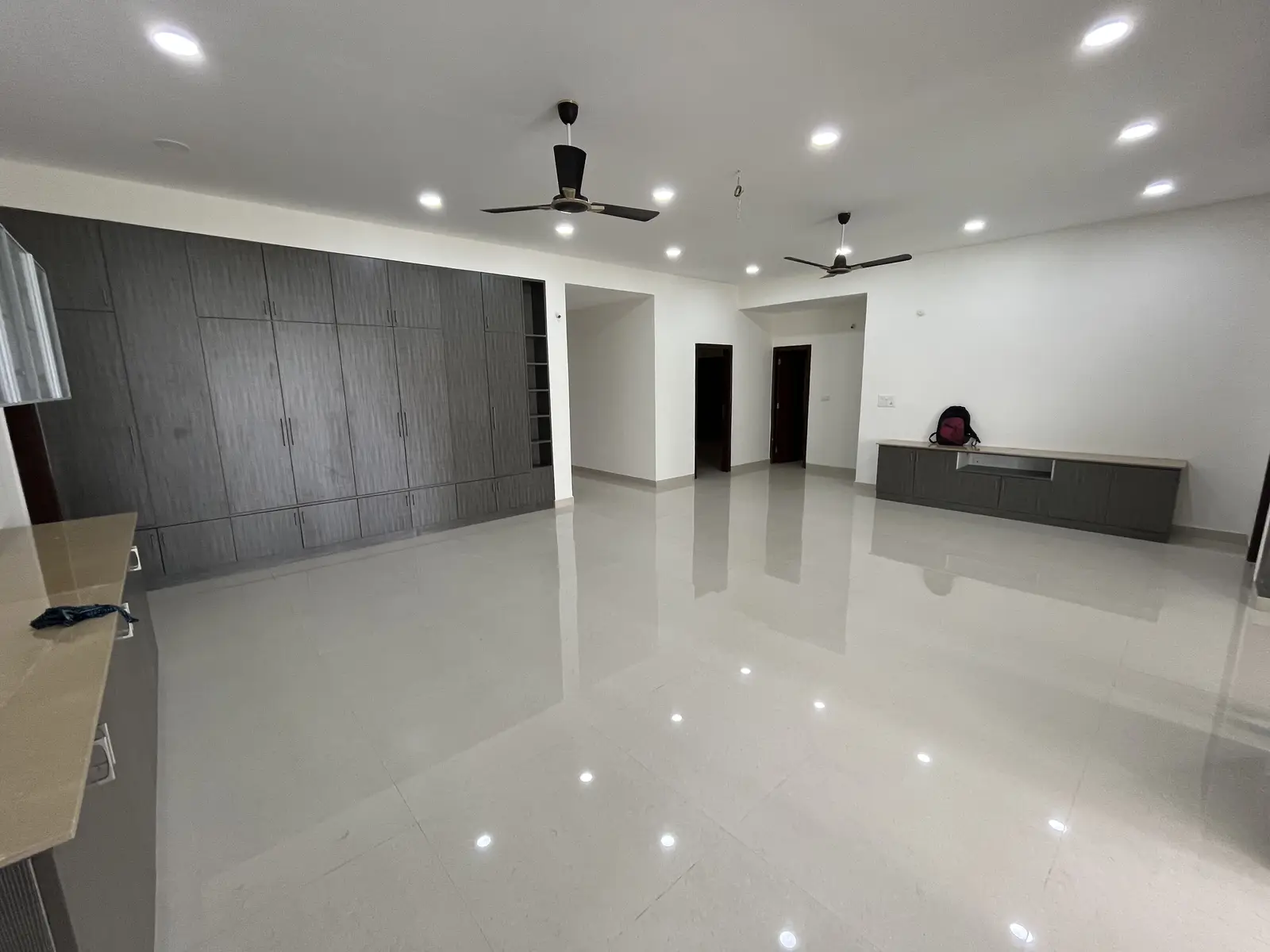 Long charcoal wardrobe wall in a large living room