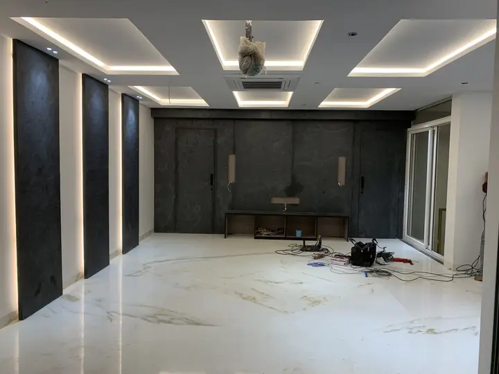 Large hall with charcoal wall panels and a lit ceiling