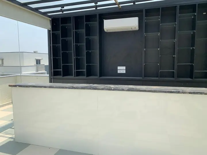 Open charcoal shelving above a white counter