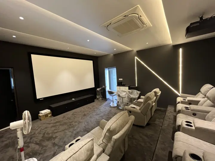 Theatre room with a wide screen and tiered seating