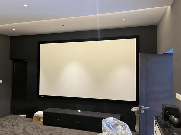 Projection screen on a black acoustic wall