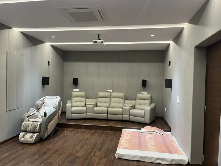 Home theatre with a screen and reclining sofa on a raised platform