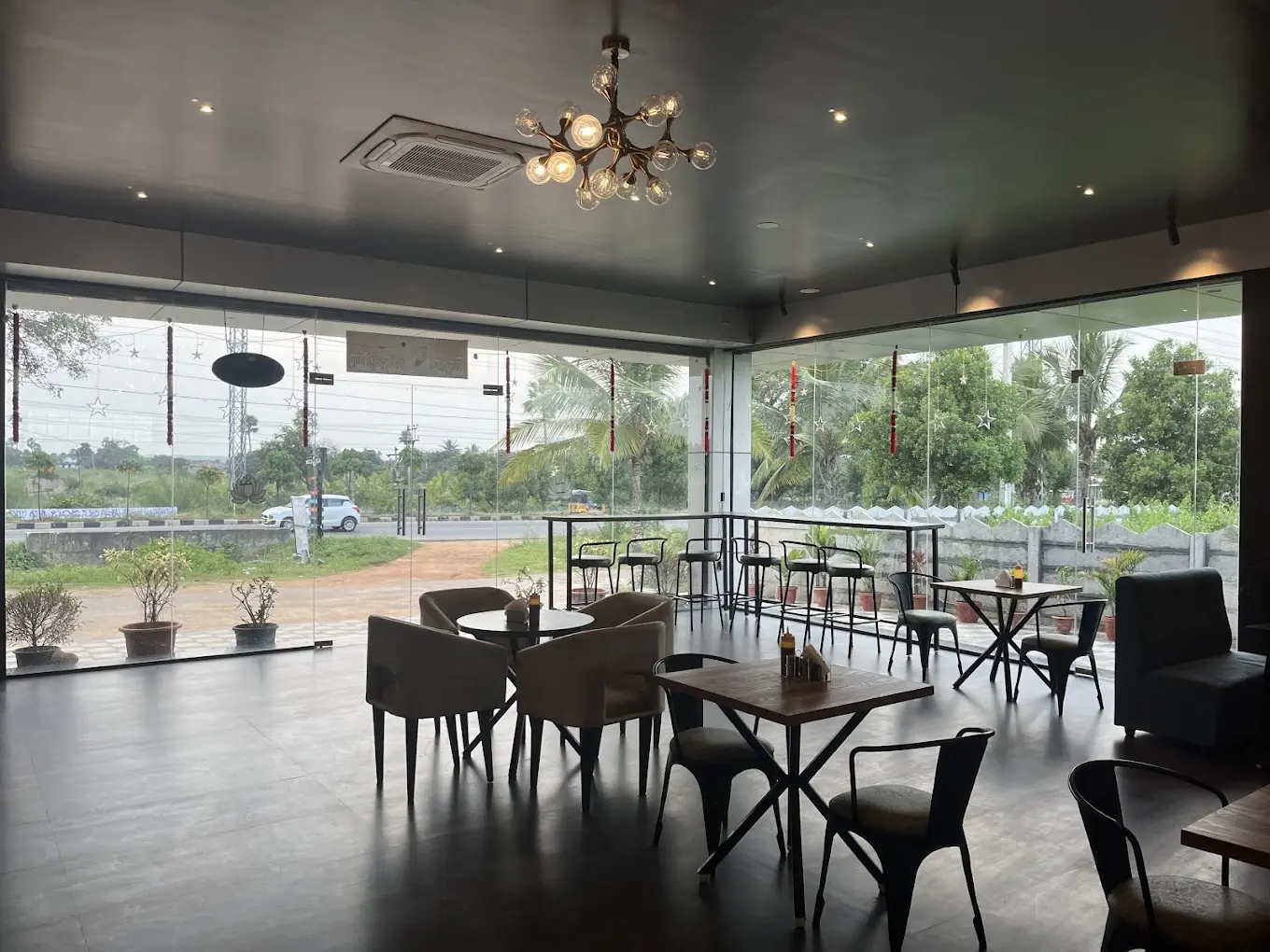 Cafe hall with glass walls and pendant chandeliers