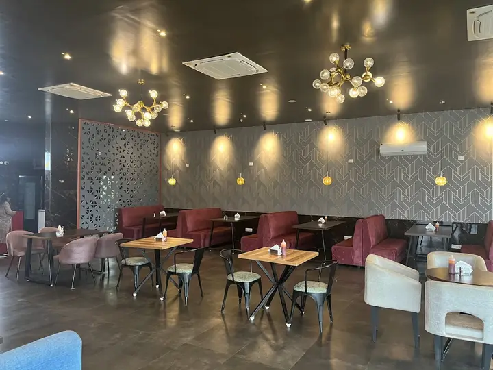 Cafe seating with pendant lights and a patterned wall