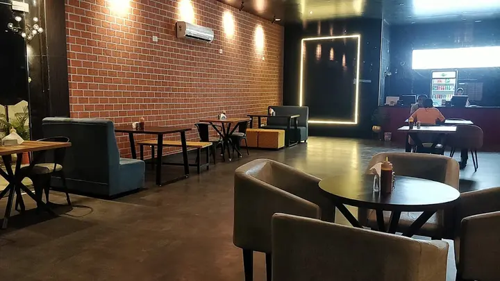 Dark cafe corner with a brick wall and booth seating