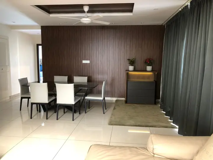 Dining area with a dark wood-panelled wall