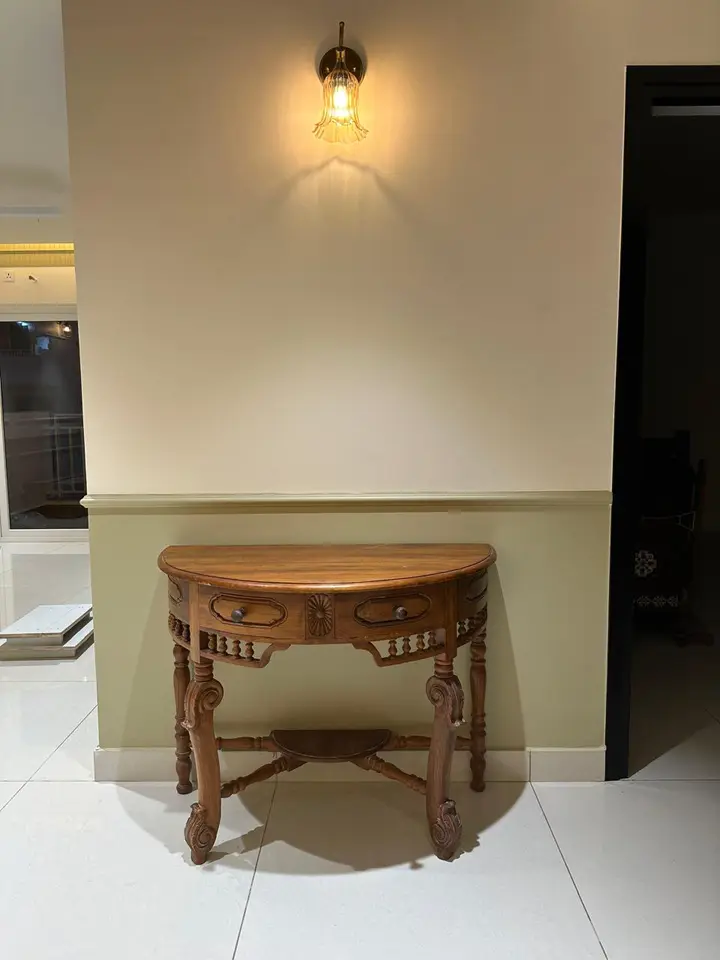 Console table beneath a wall light