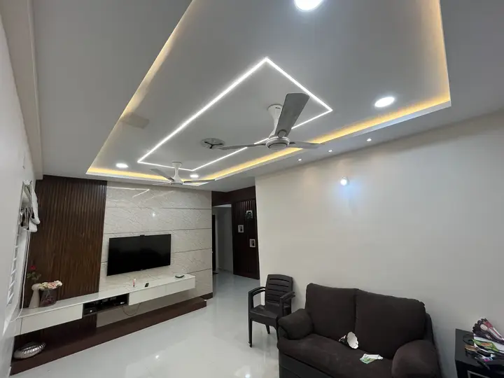TV unit with grey panels under a lit ceiling frame