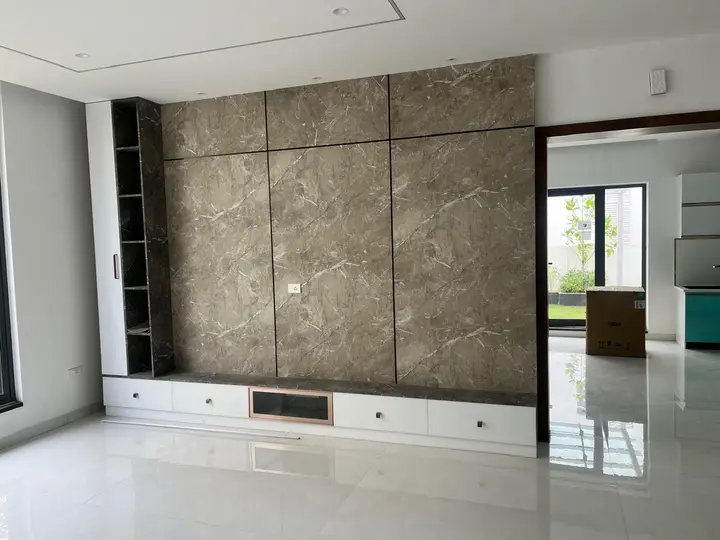 Stone-look TV wall with a white console