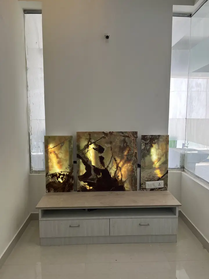 Media console with a lit artwork panel