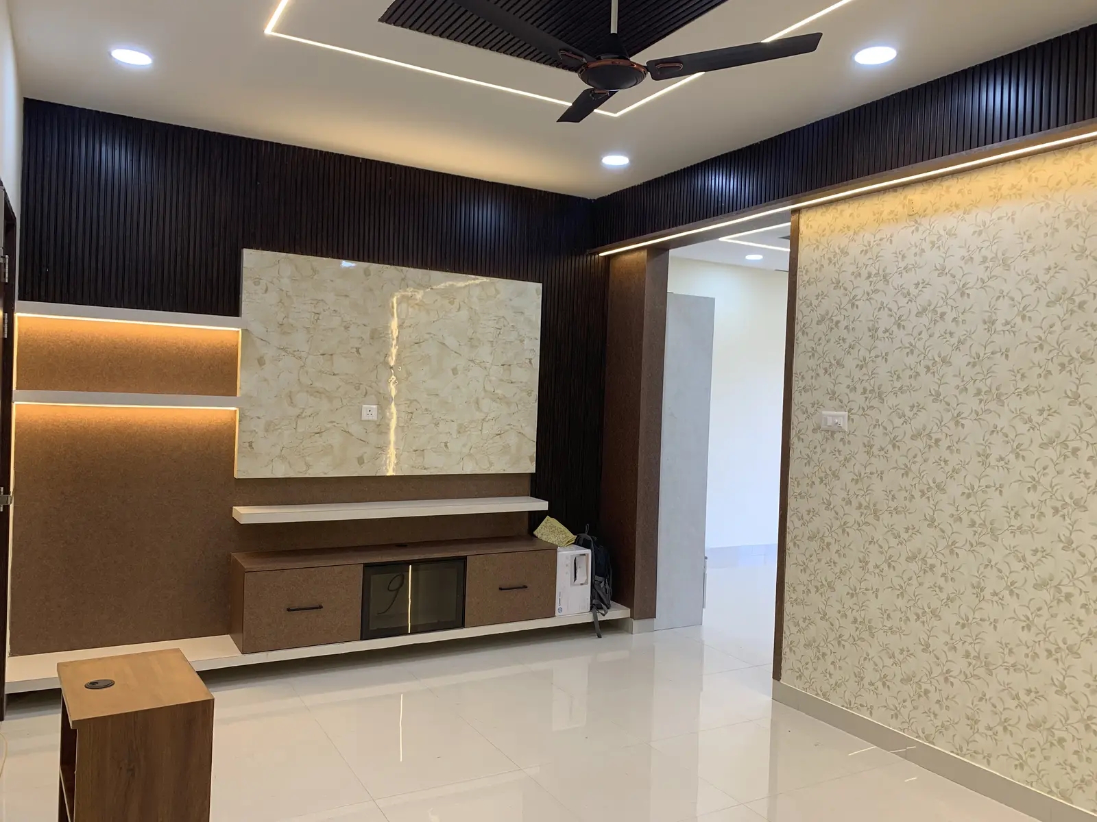 TV console against a lit gold-patterned wall