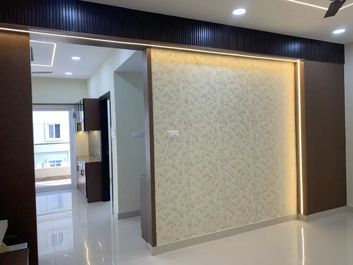 Gold-patterned feature wall with a lit timber frame