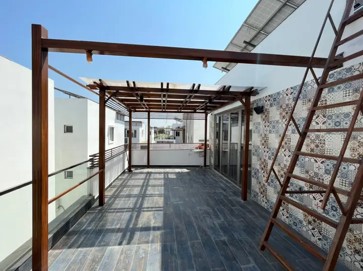 Terrace pergola with a timber trellis and patterned wall