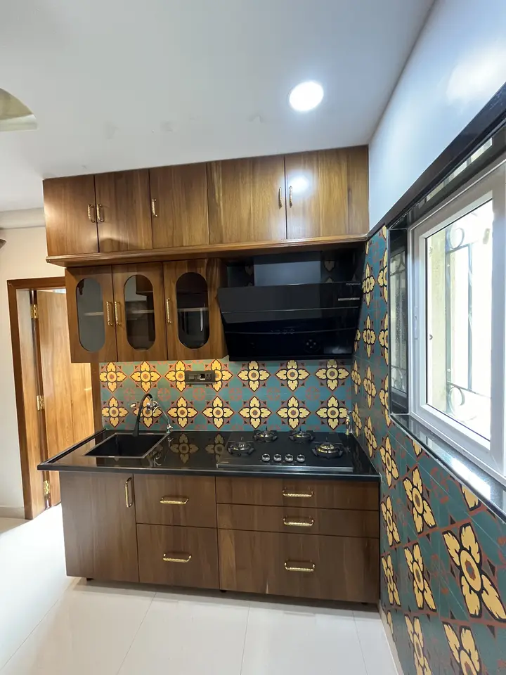 Walnut kitchen cabinets with patterned tile backsplash