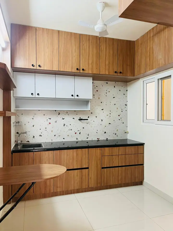 Kitchen with timber base cabinets, white shutters and patterned tile