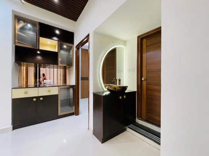 Dark timber console with a round mirror beside the door