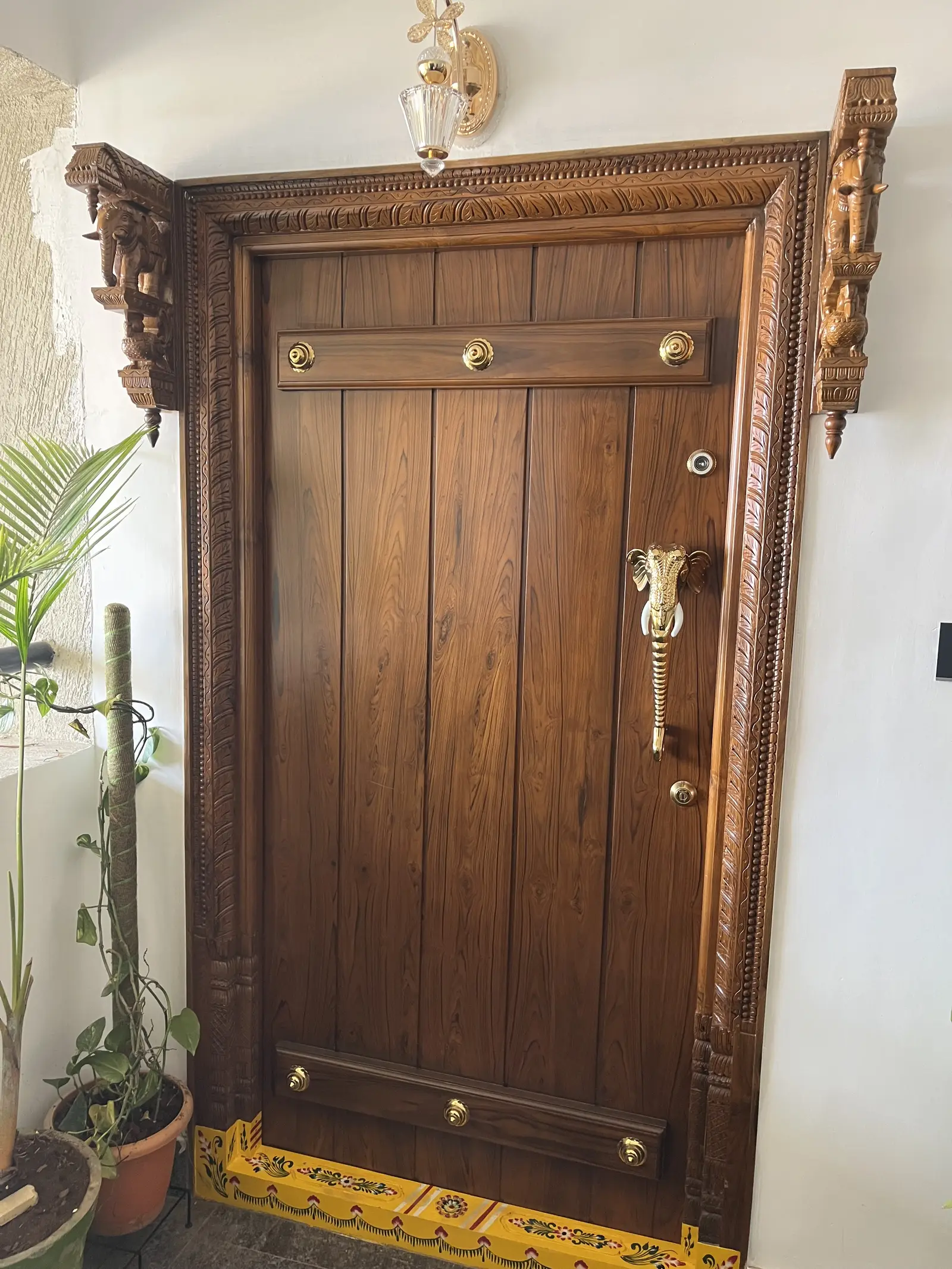 Carved timber entrance door with brass fittings