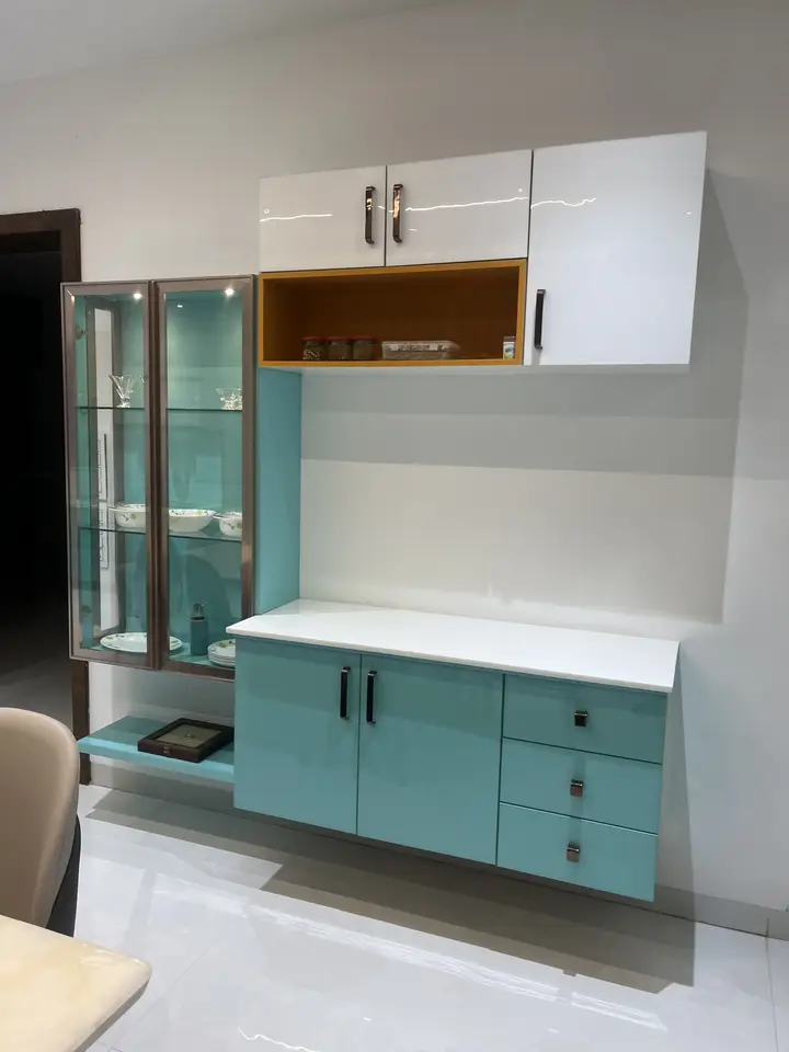 Teal display unit with white cabinets and glass shelves