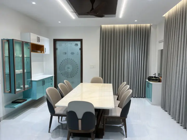Dining area with teal glass display cabinets