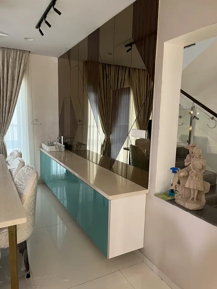Teal sideboard beside a timber partition and curtains