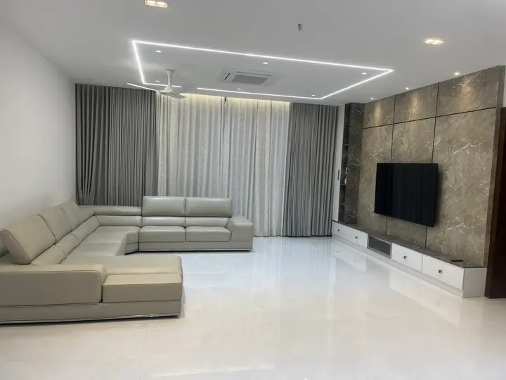 Living room with a sectional sofa and stone TV wall