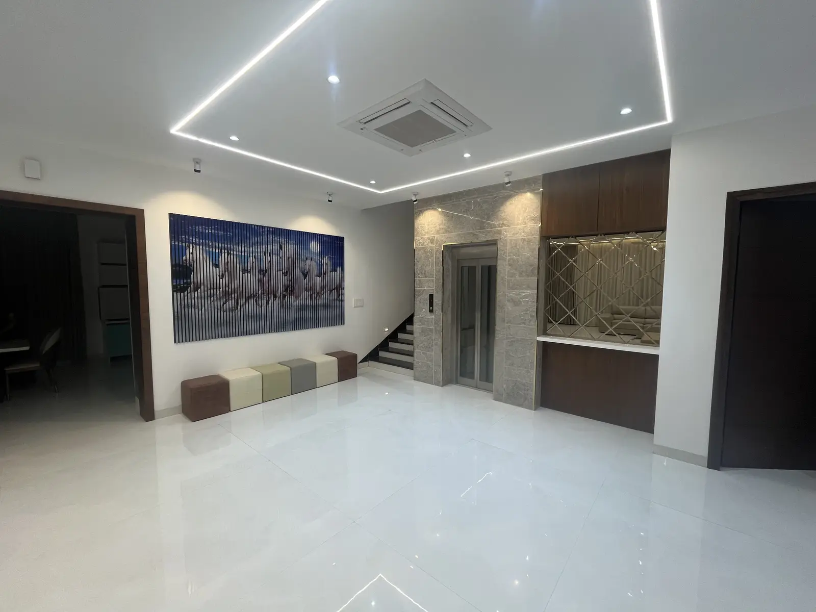 Living area with a large artwork and a timber panel