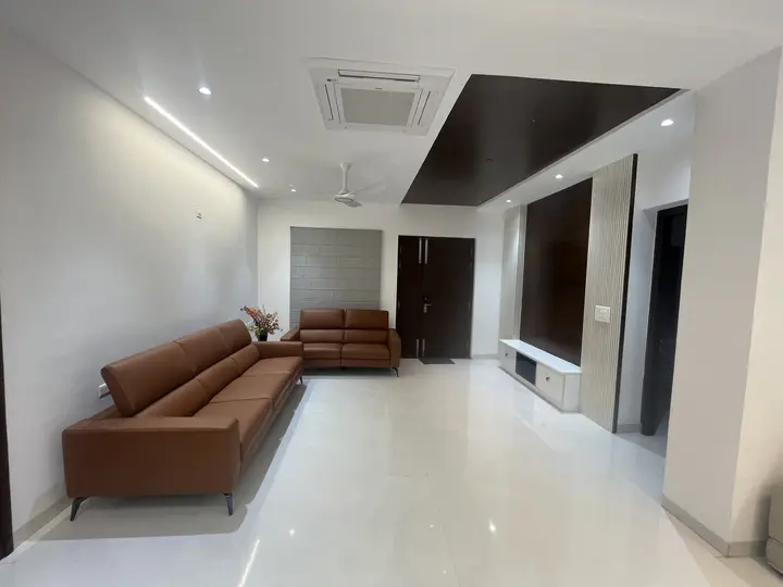 Leather sofa set in a living room with grey curtains