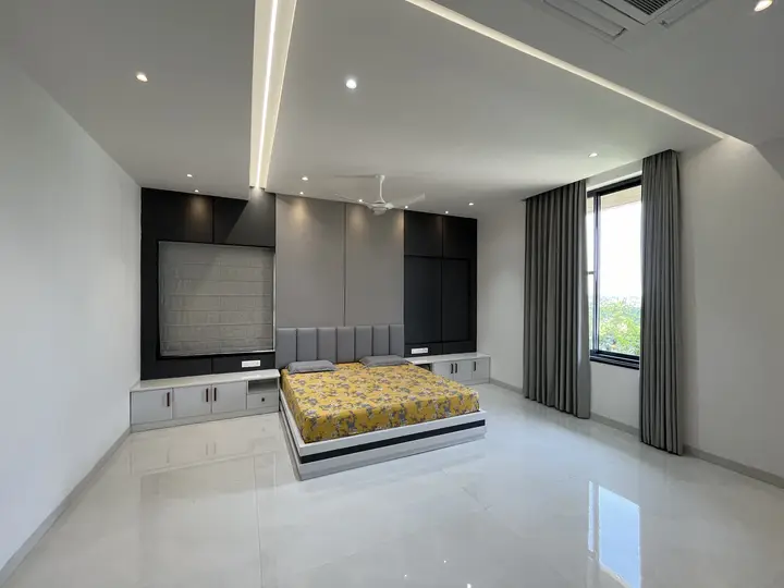 Master bedroom with a grey upholstered headboard wall