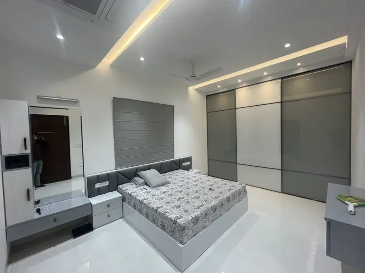 Bedroom with floor-to-ceiling grey wardrobes