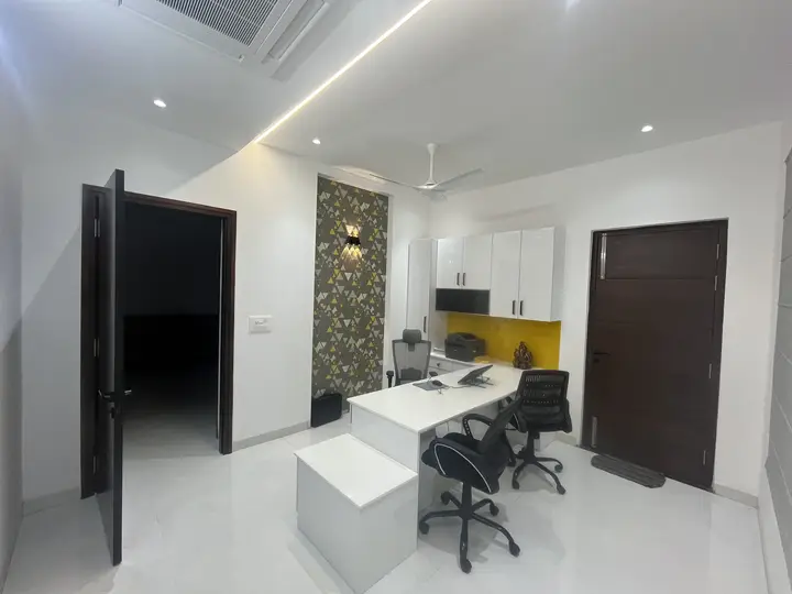 Study with a white desk, yellow panel and stone wall