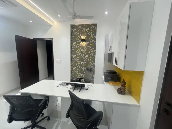 Office desk with a stone feature wall and yellow shelf