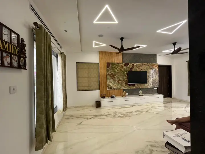 Living room with a marble floor and a carved wall panel