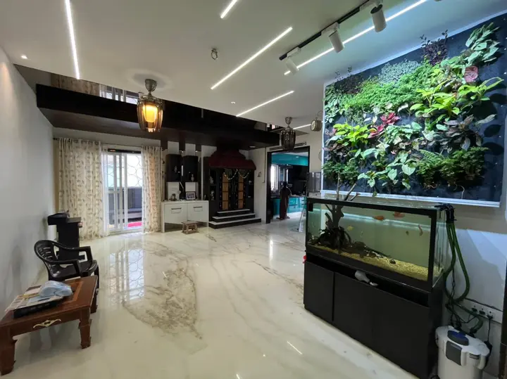 Entrance hall with a fish tank and a planted wall