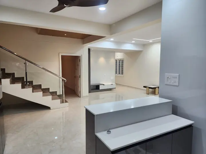 Staircase with a glass balustrade beside a breakfast counter