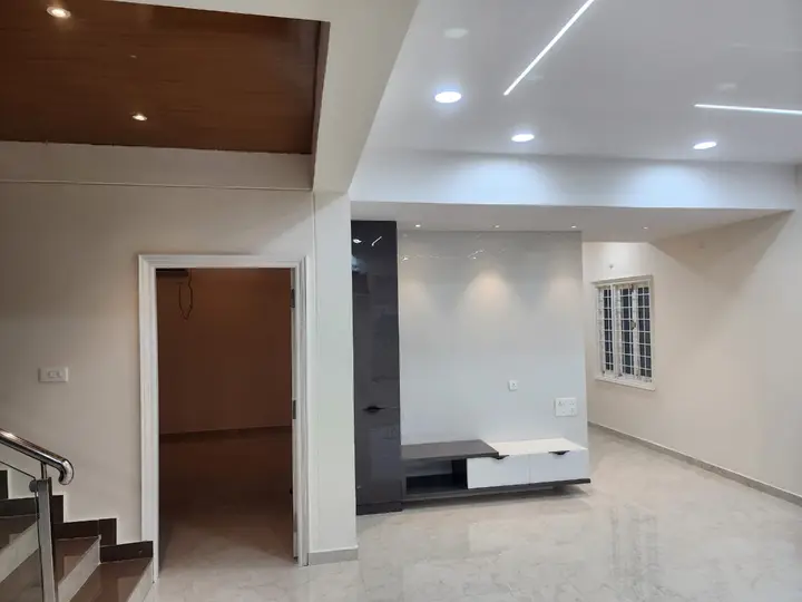 Living area with a TV unit and a timber ceiling drop