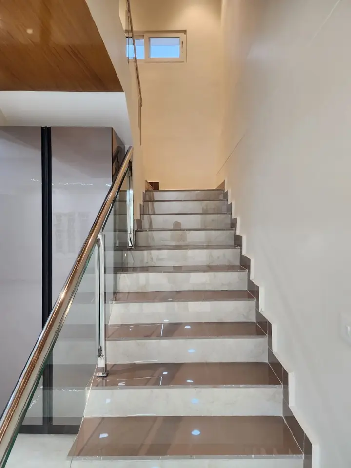 Staircase with timber-clad risers and a glass balustrade